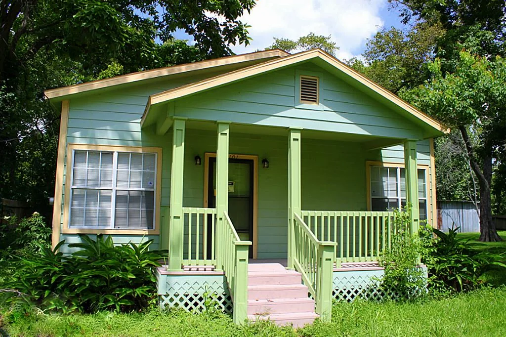 Front exterior of 7101 Wendemere St showing porch, entry hardware, windows, lighting, and exterior paint context