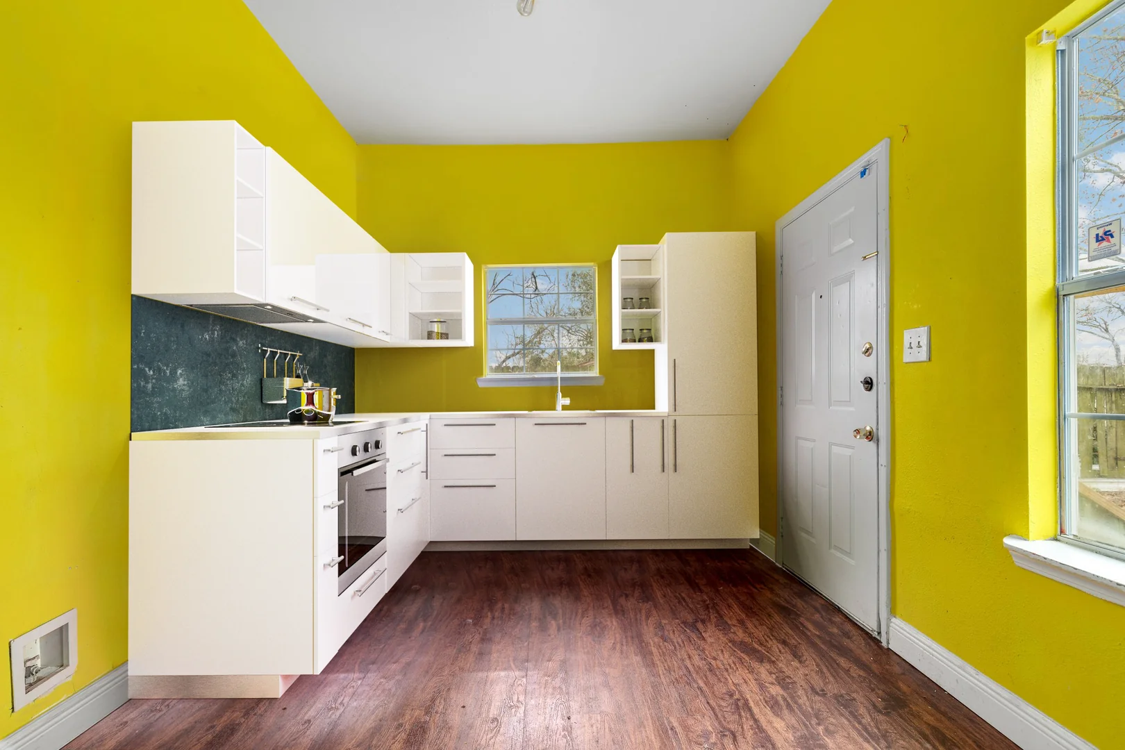 Kitchen interior showing plumbing, outlet, door, flooring, and wall finish context at 7101 Wendemere St